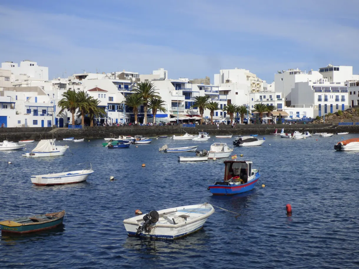 Fishing boats moored in front of the white facades