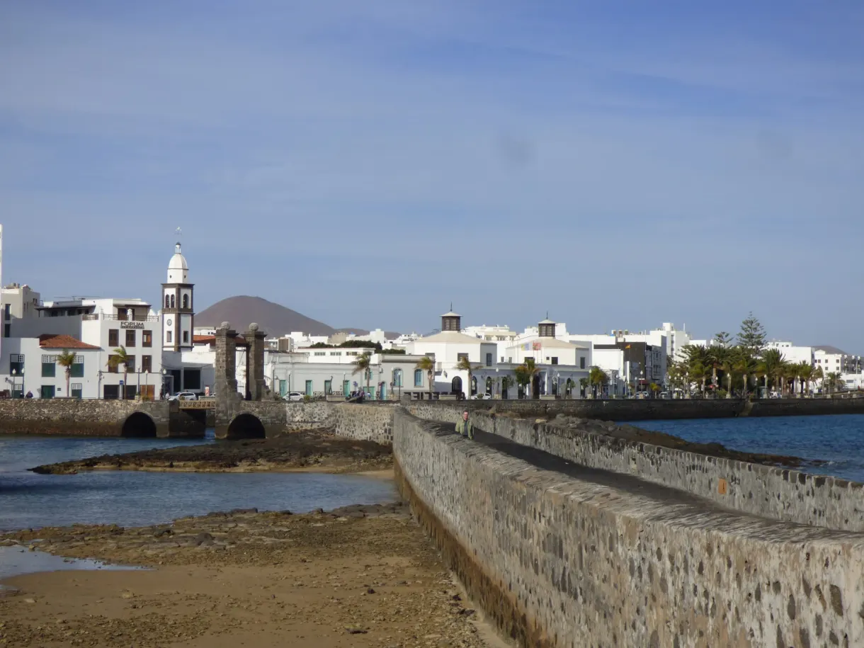 White seafront and bell tower seen from the fort