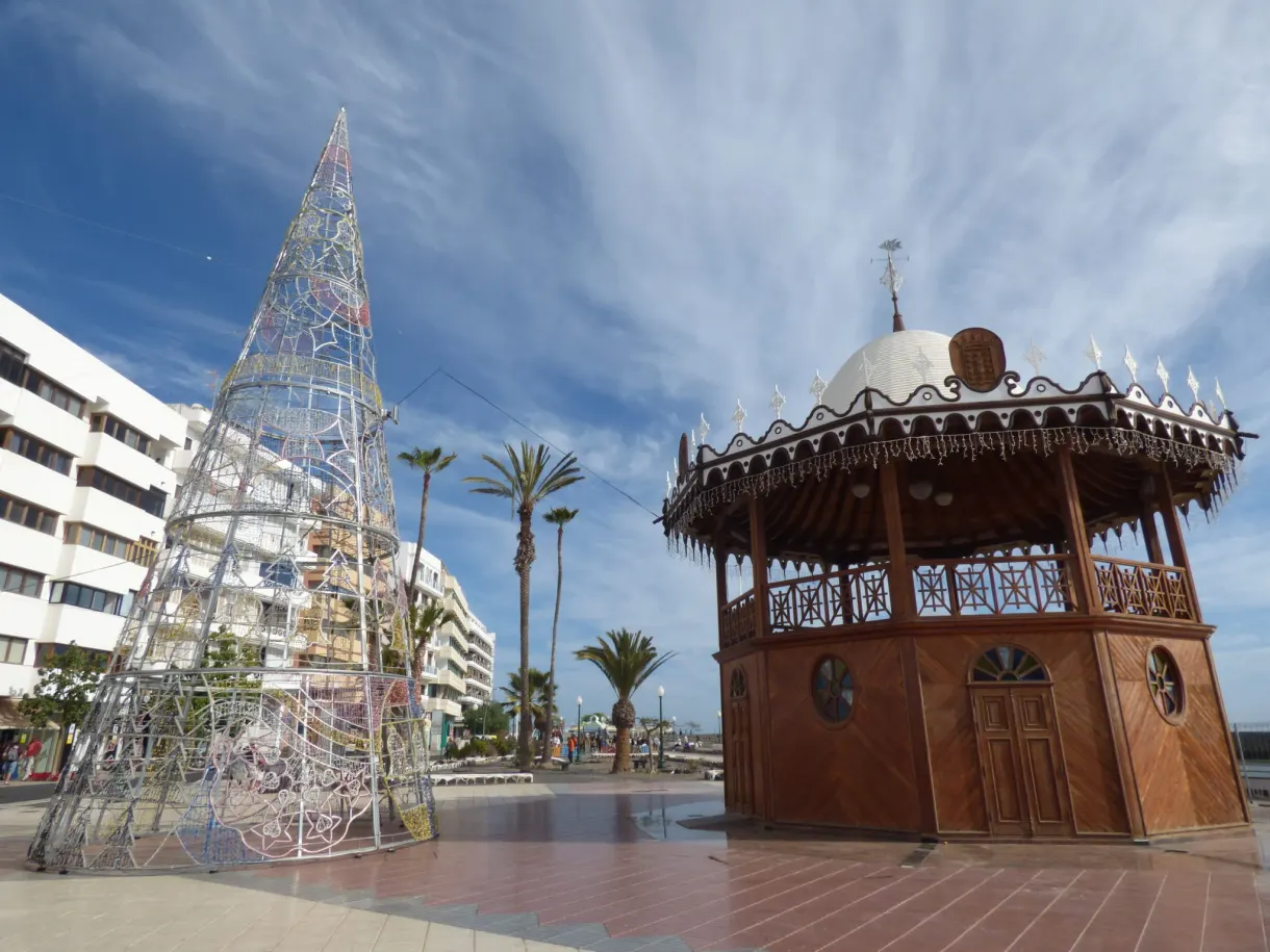 Wooden bandstand and lit Christmas tree on a square
