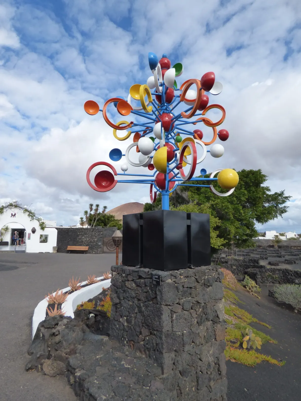 Colourful metal mobile standing above the volcanic stones