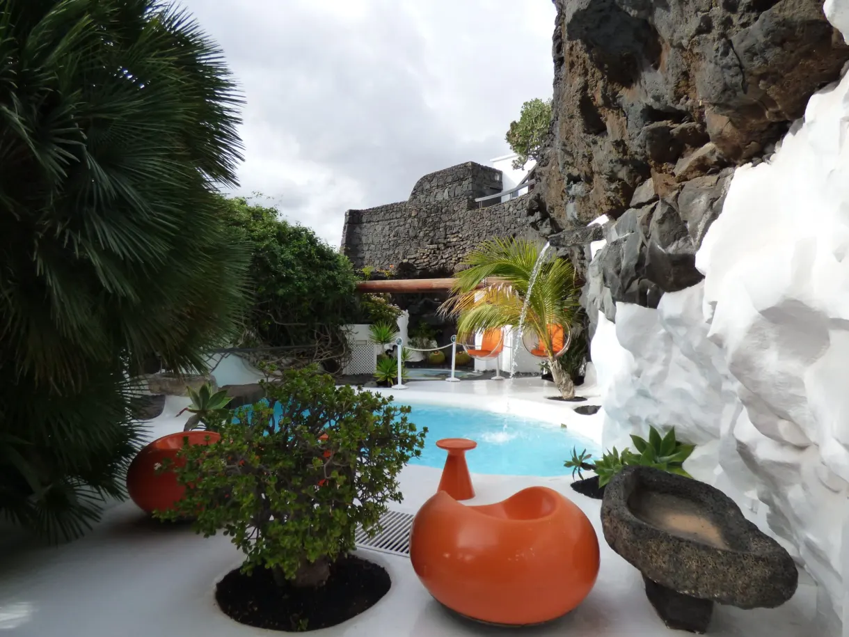 Pool and orange jars nestled between the lava walls