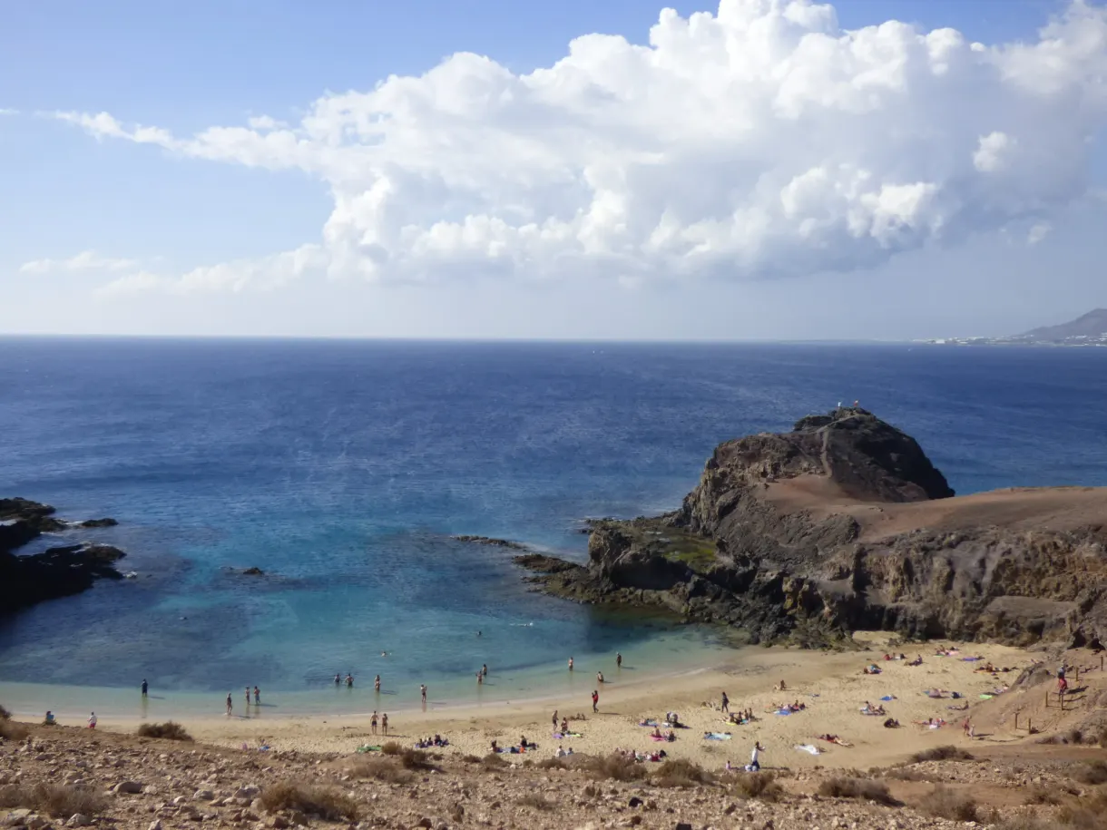 Crique turquoise et baigneurs entre les falaises de Papagayo