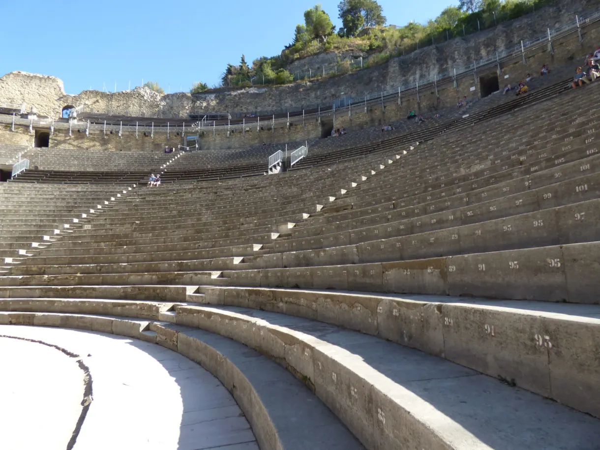 Curved stone tiers and staircases of the Roman theatre