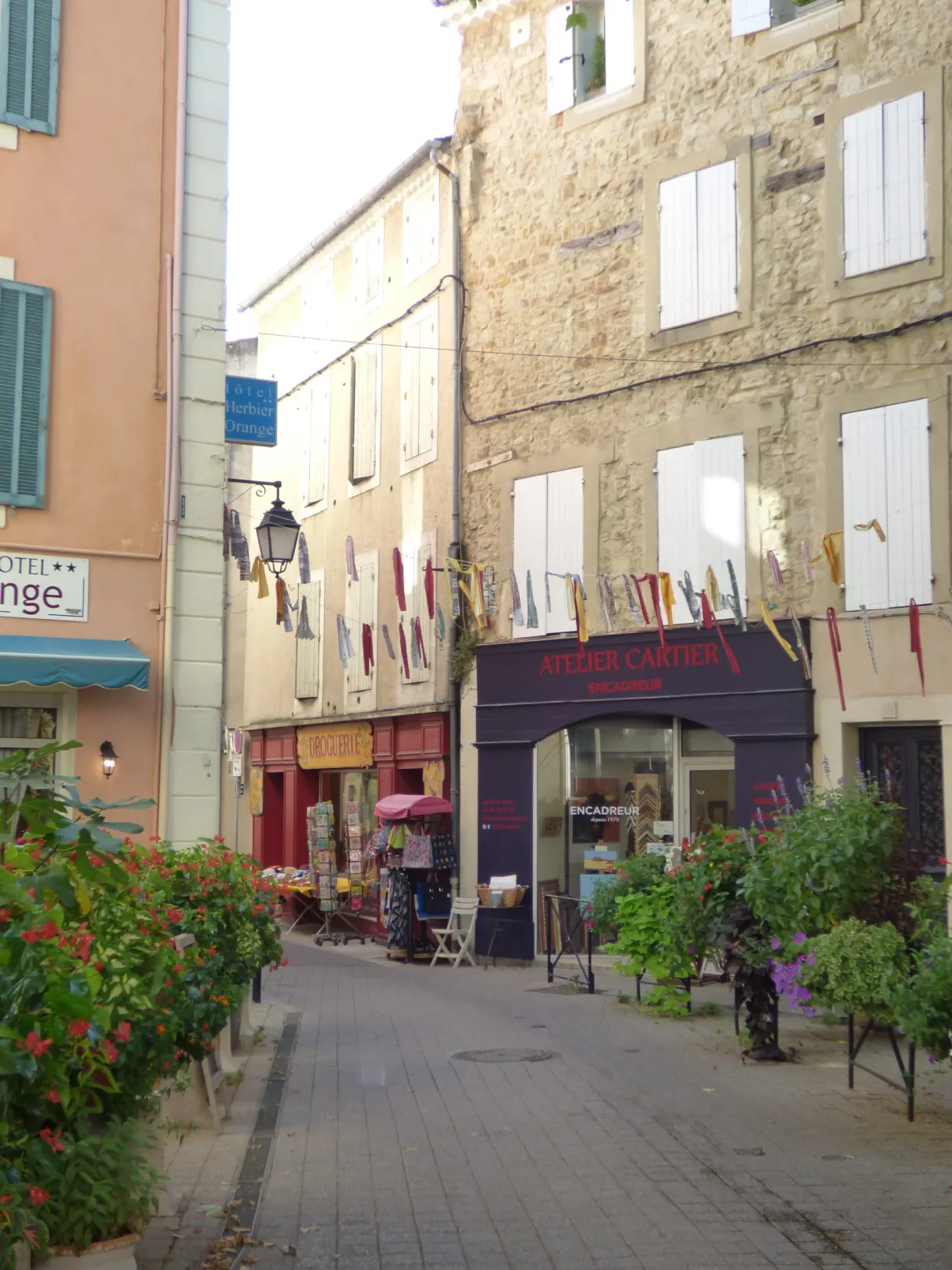 Shopping street decked with bunting, white shutters and shops