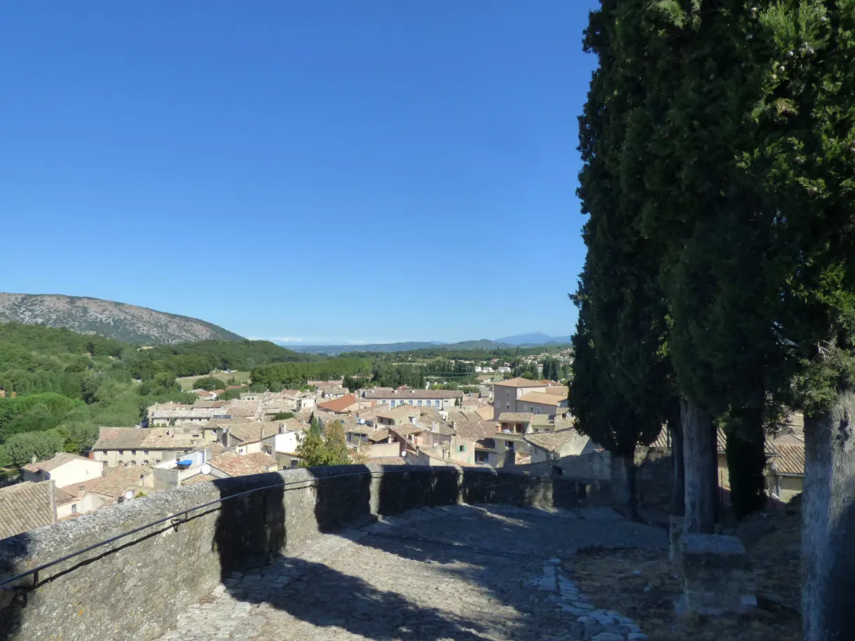 Terrace overlooking the roofs of the village, cypresses and peaks on the horizon