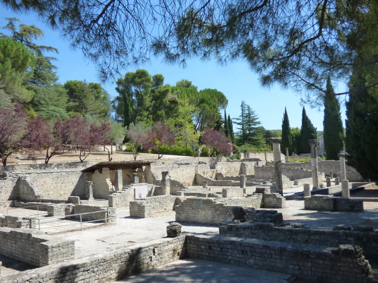 Roman archaeological site with its low stone walls and cypresses