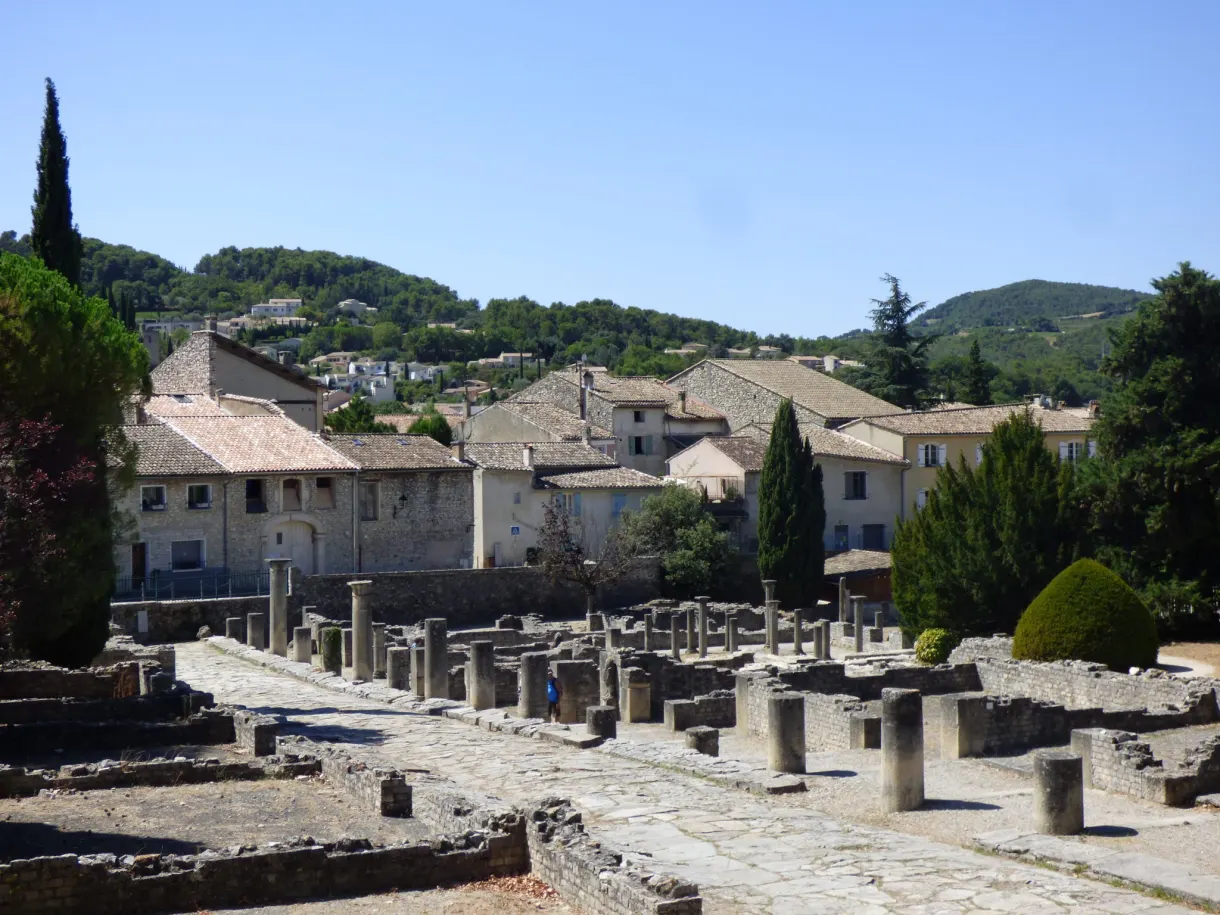Truncated columns of the ancient site in front of the village houses