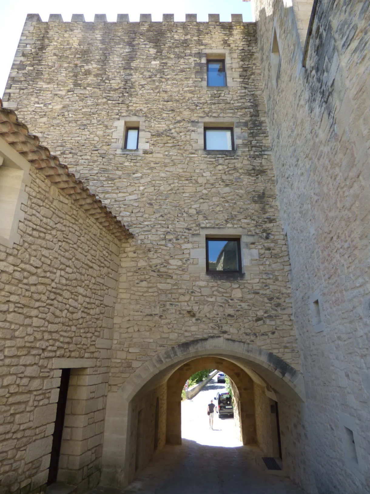 Vaulted porch opening beneath a tall crenellated tower