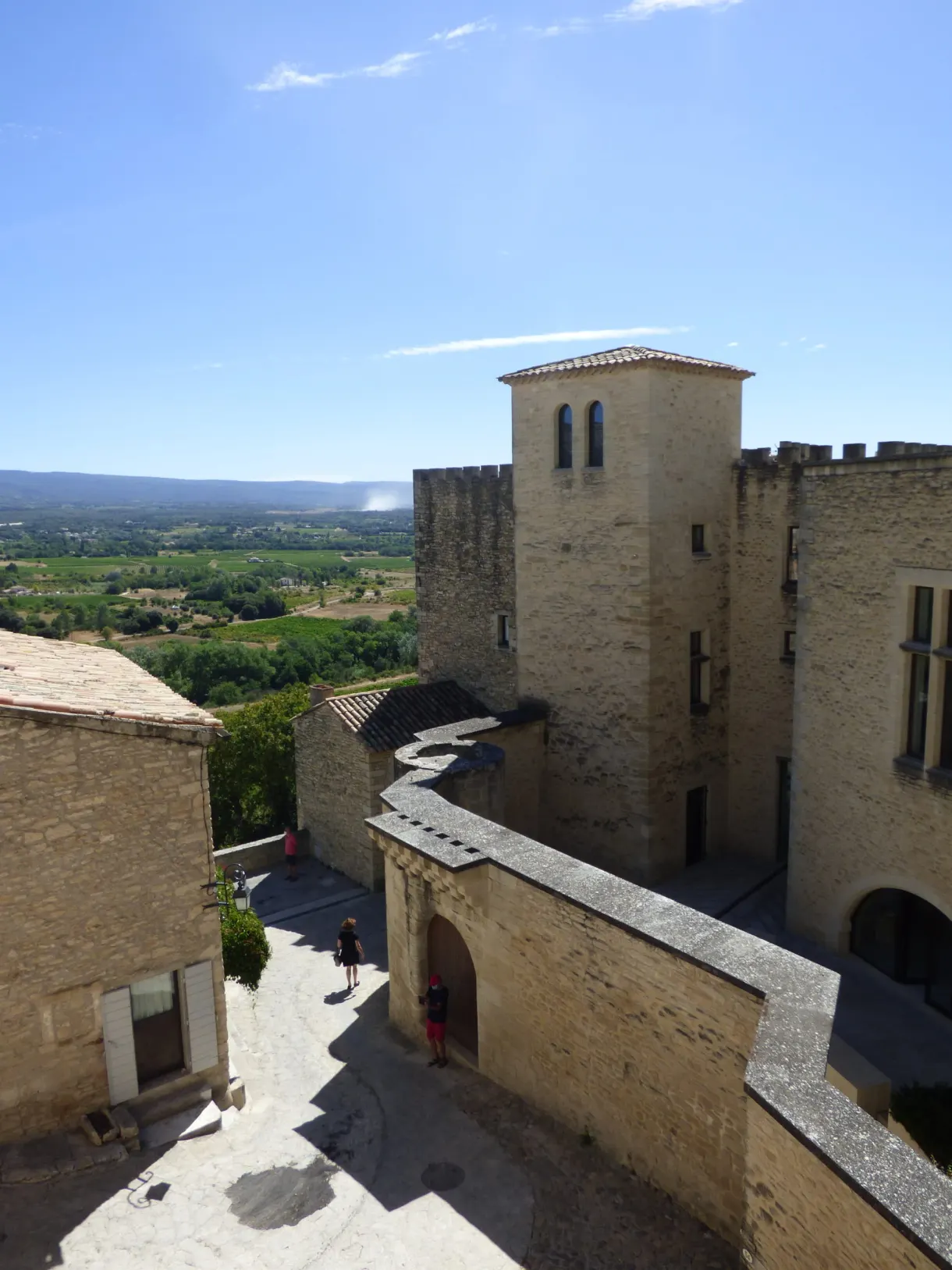 Fortified building and its tower beside the sloping street