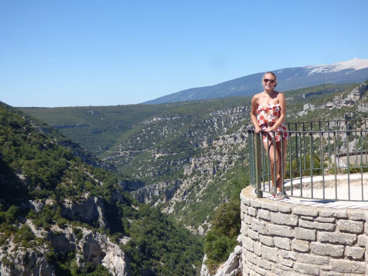Woman at the railing of a platform overhanging the canyon