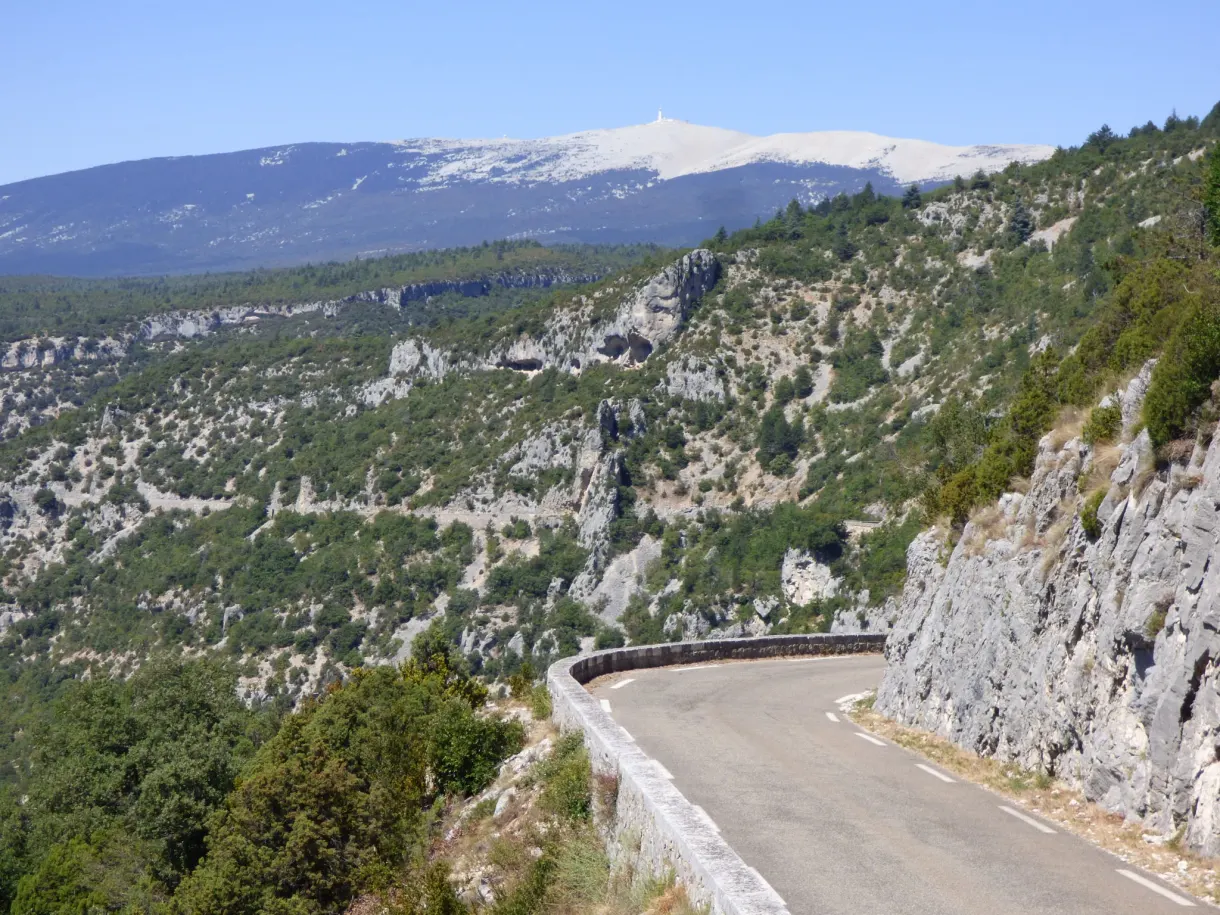 Bare summit of Mont Ventoux above the cliffs and the hairpin road