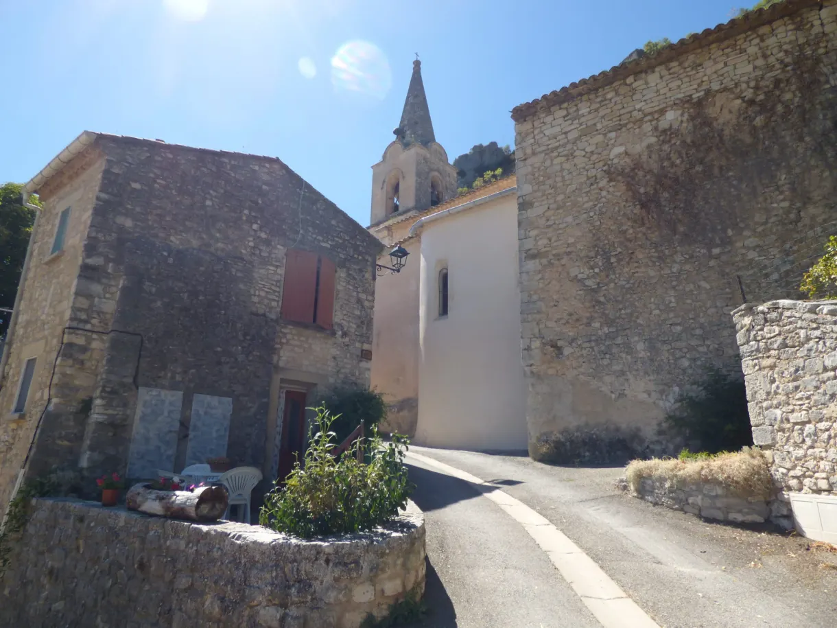 Hamlet lane leading to the bell tower between stone houses