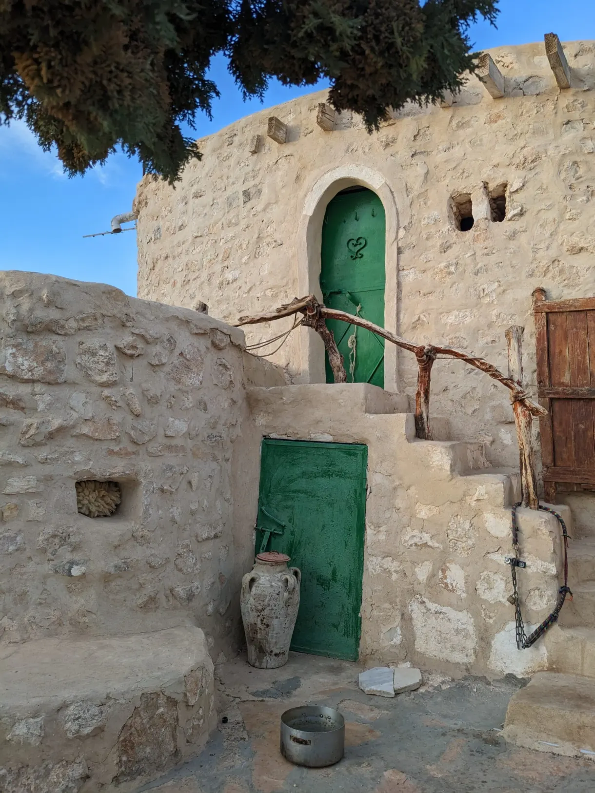 Maison berbère en pierre aux portes vertes du Café Berbère Ben Jemma à Tamezret
