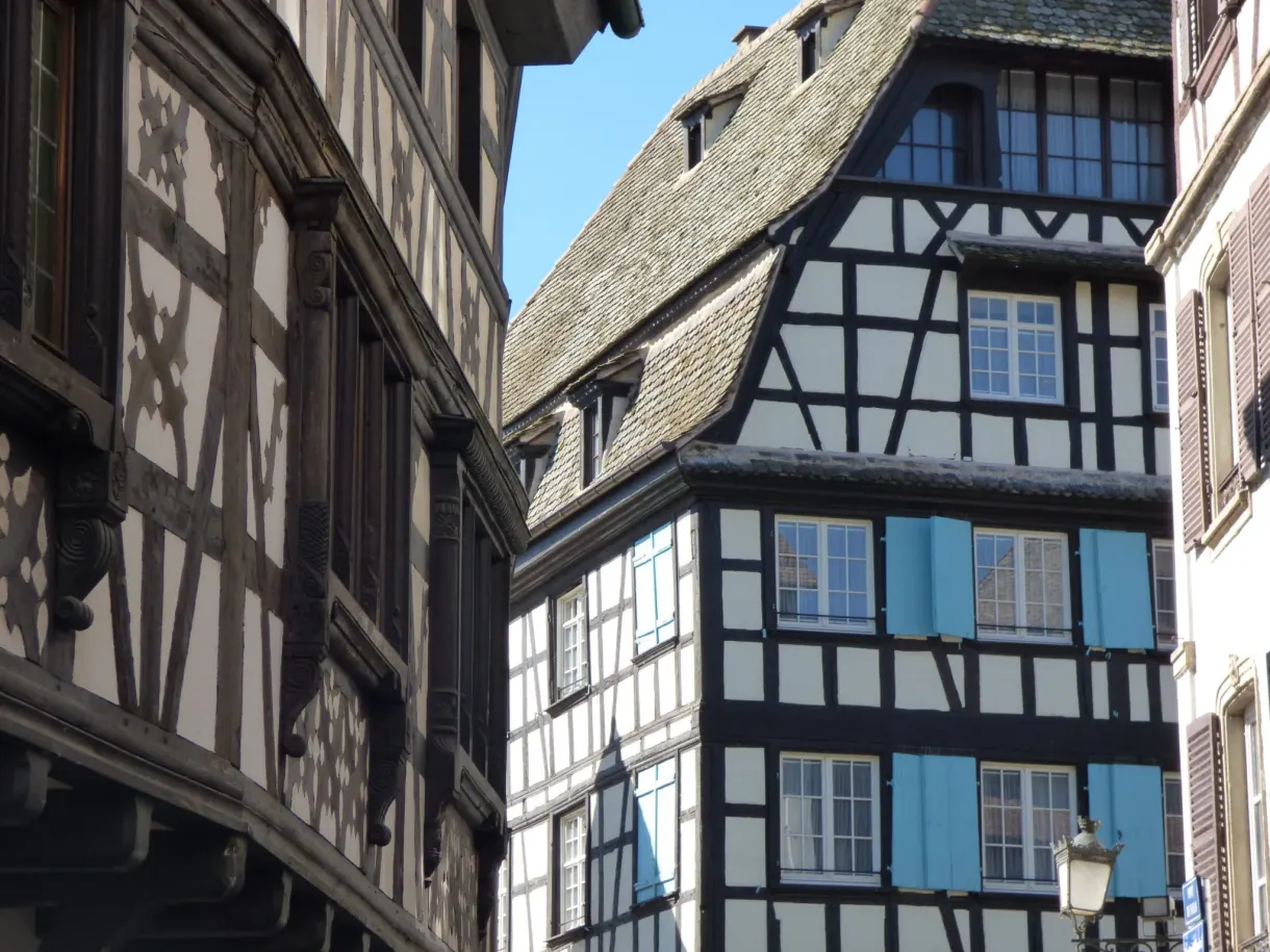 Dark half-timbered facades packed along a narrow lane