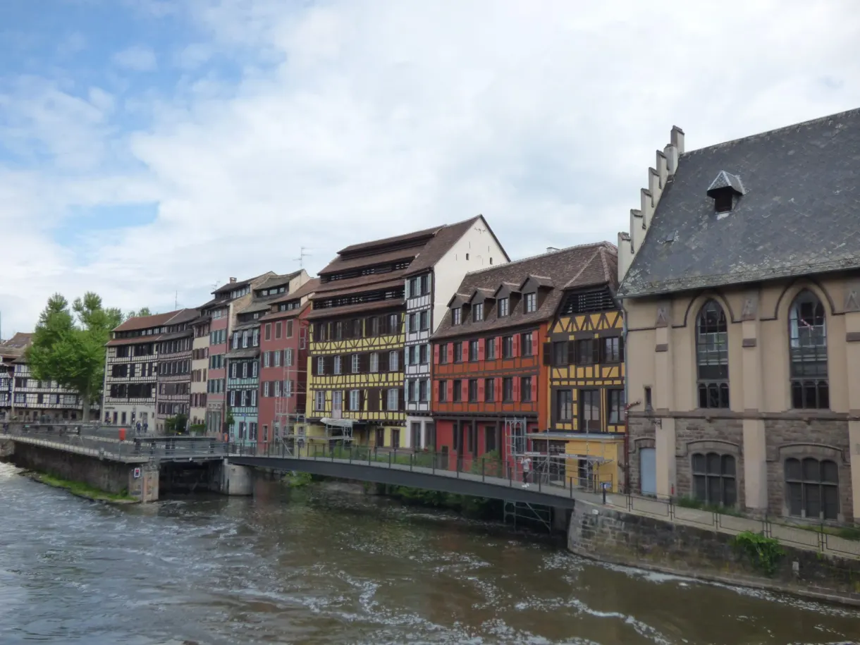 Row of colourful houses at the edge of the choppy water