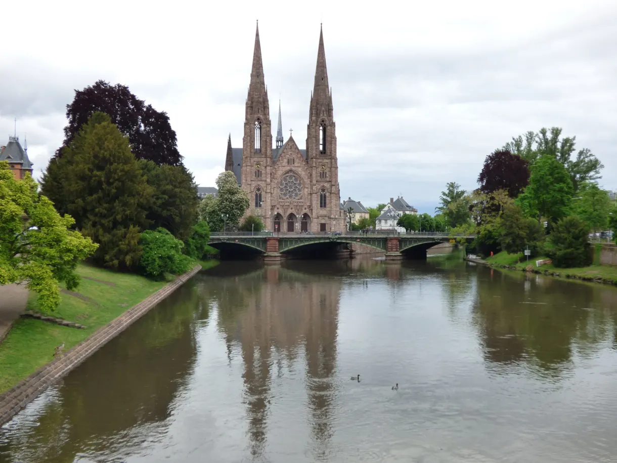 Neo-Gothic church with two spires on the bank of the Ill