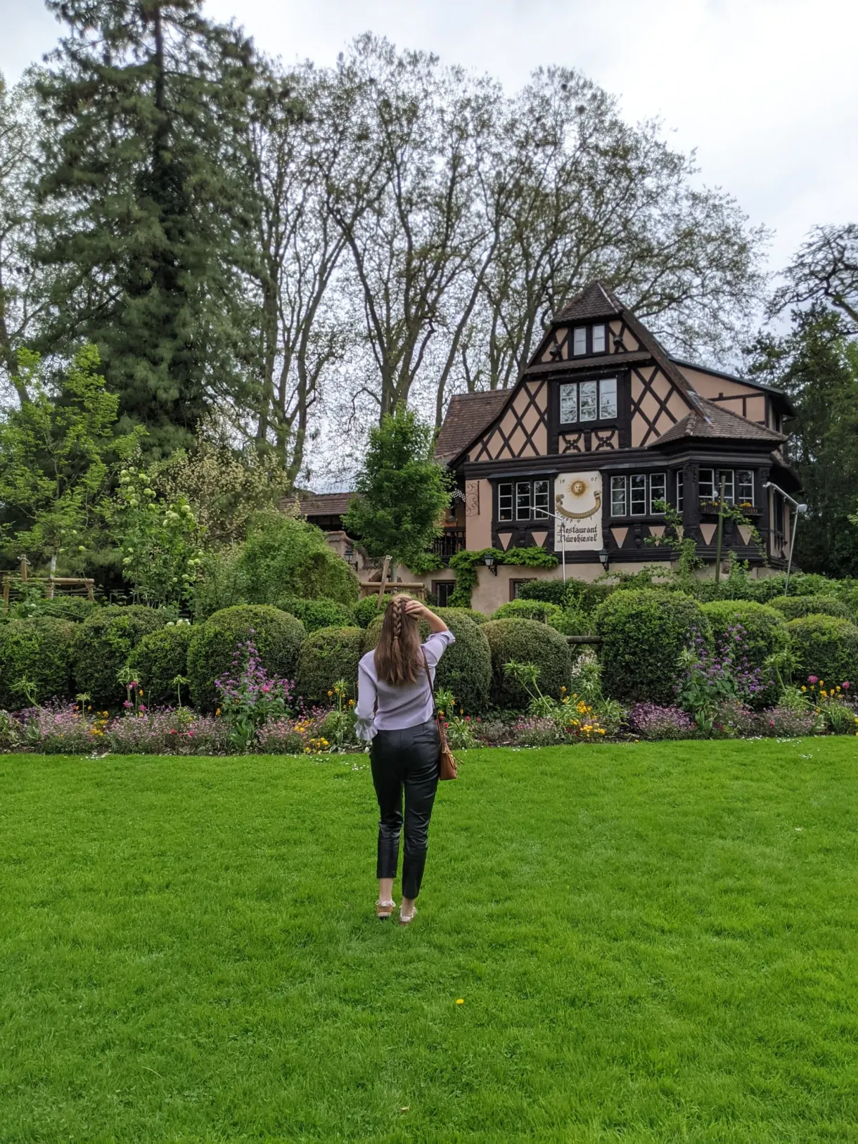 Traveller on the lawn in front of a half-timbered chalet