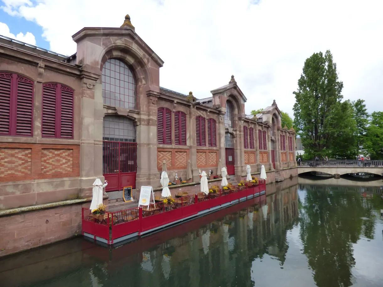 Red brick covered market reflected in the canal