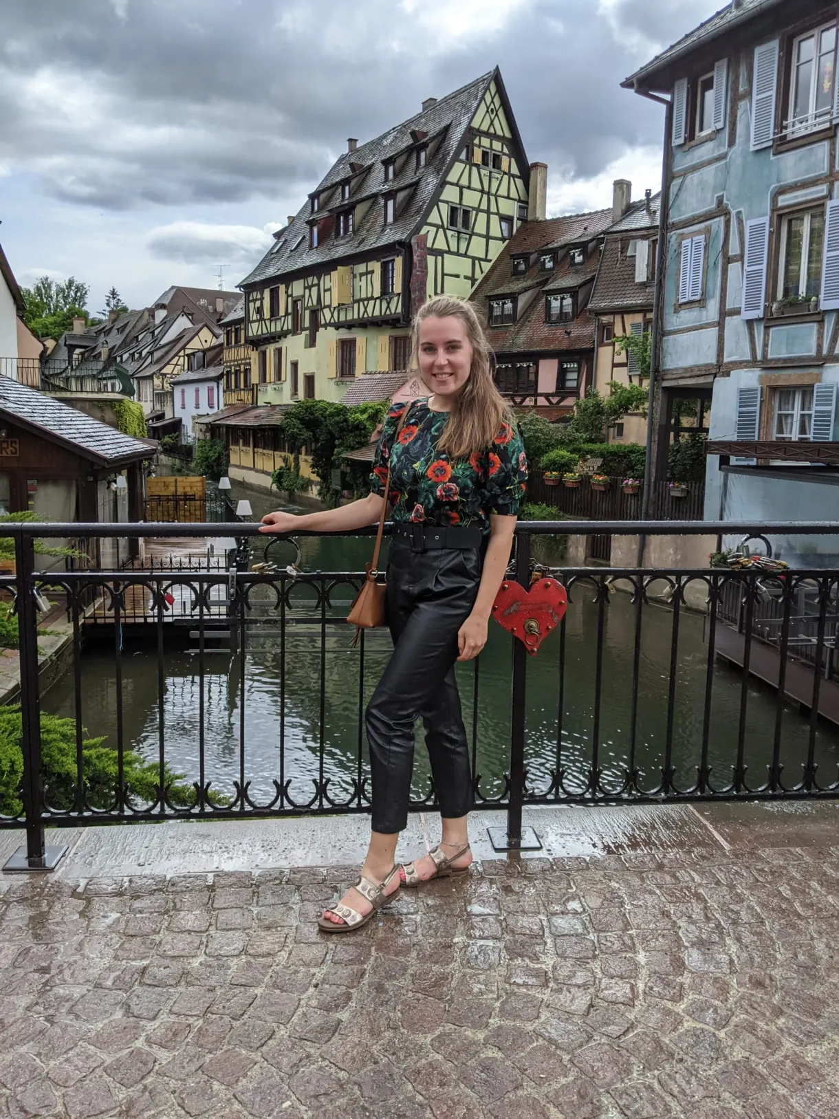 Traveller leaning on the parapet of the bridge over the canal