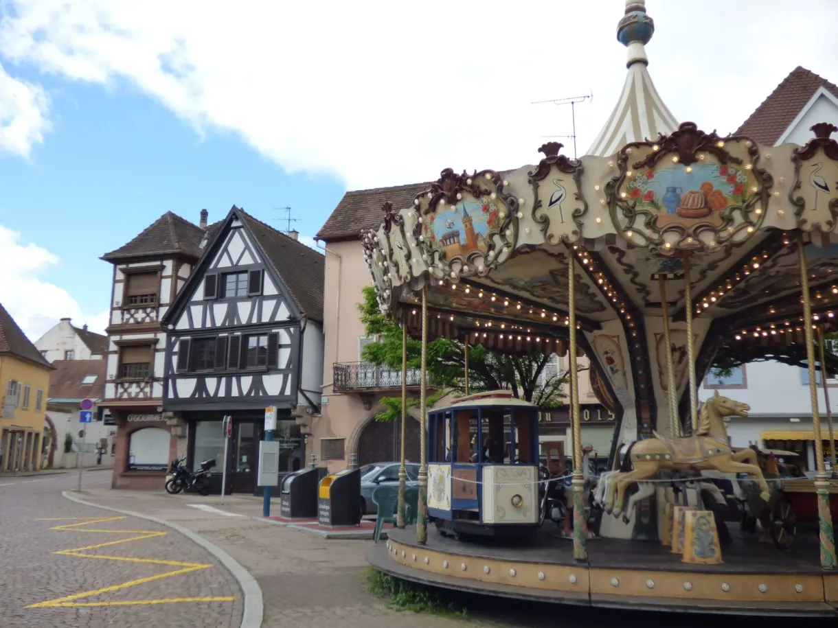 Old carousel set up on a square facing the old houses