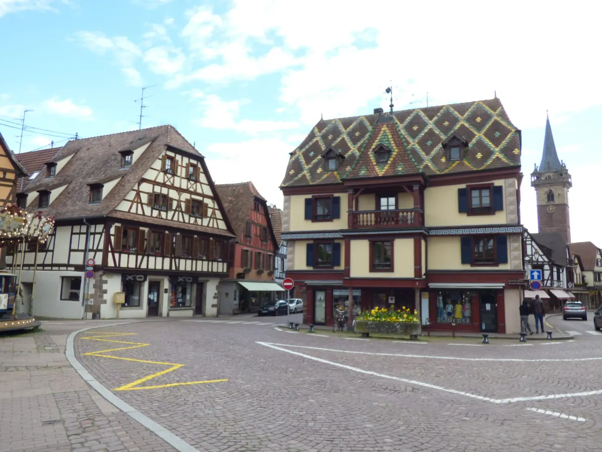 House with a glazed tile roof on the corner of the square