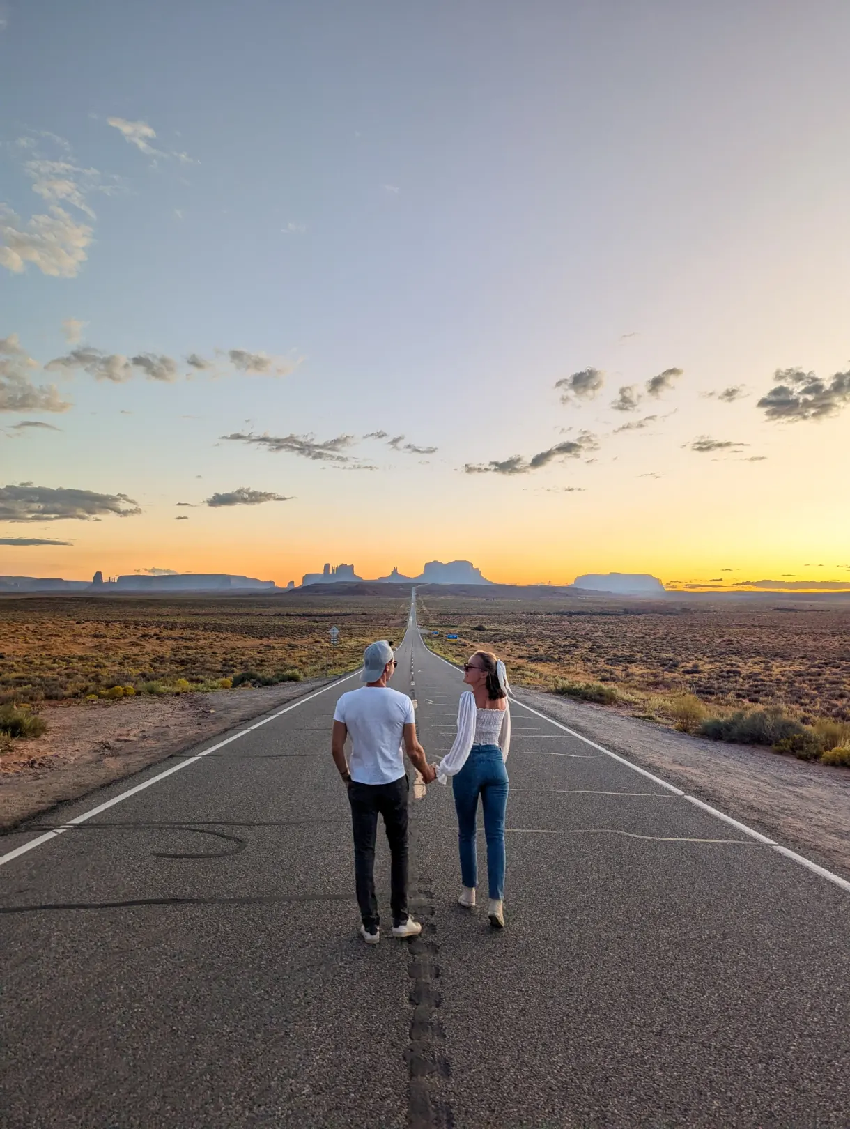 Marie and Romain on the road to Monument Valley at sunset