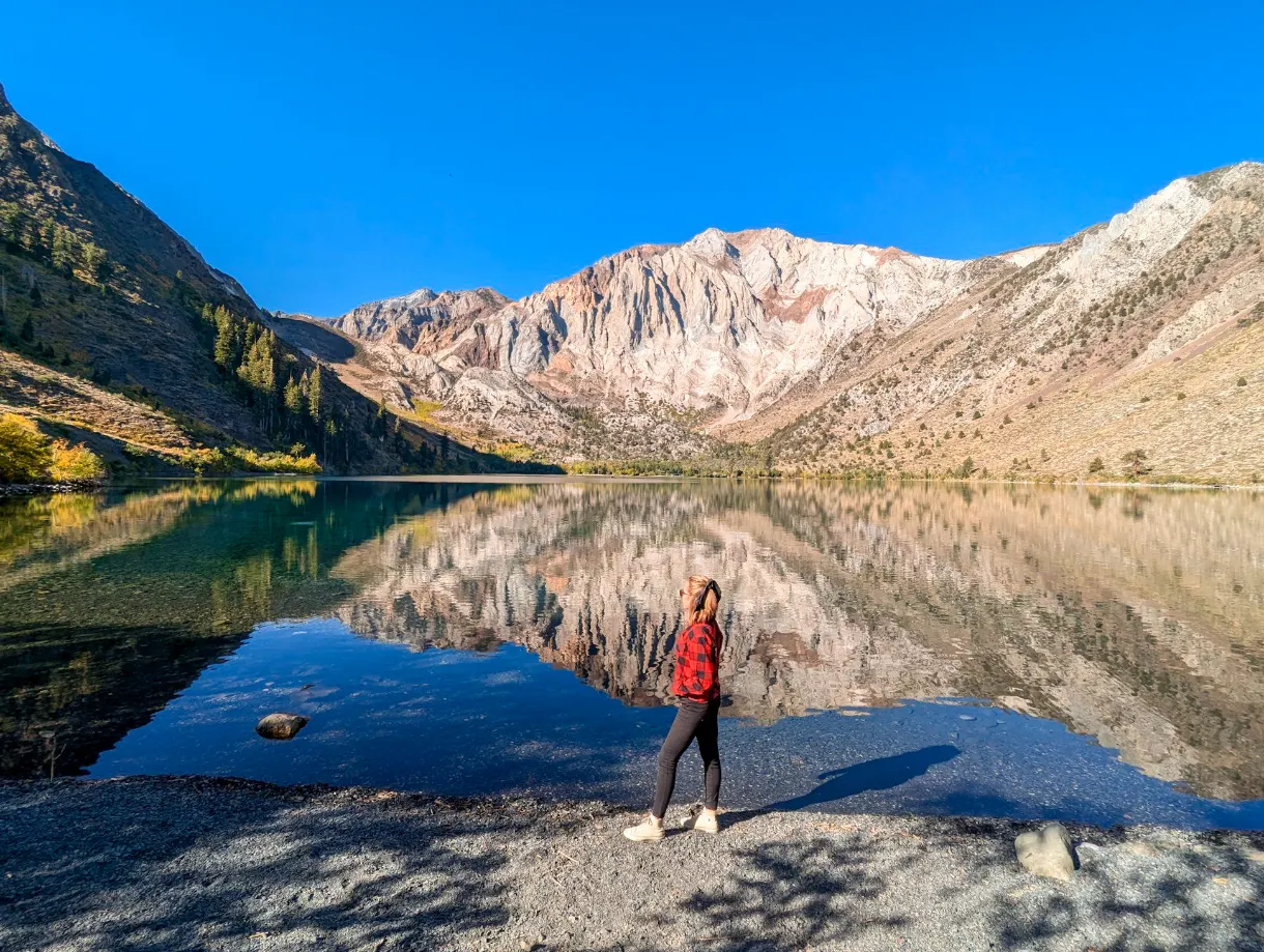 mountain landscape with its reflection in the lake, Marie standing in front in a red shirt, Convict Lake