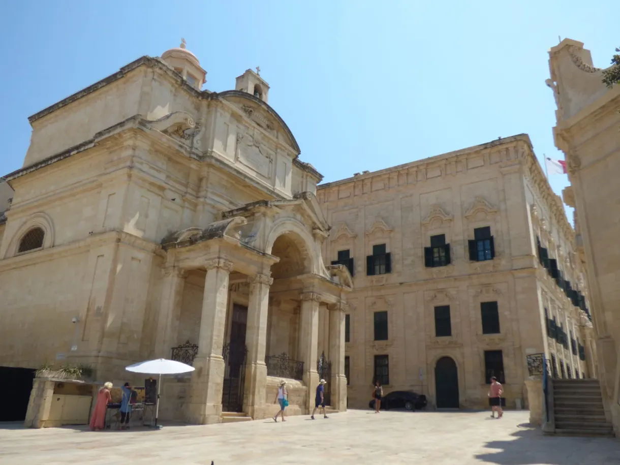 Baroque church and golden facades around a busy square