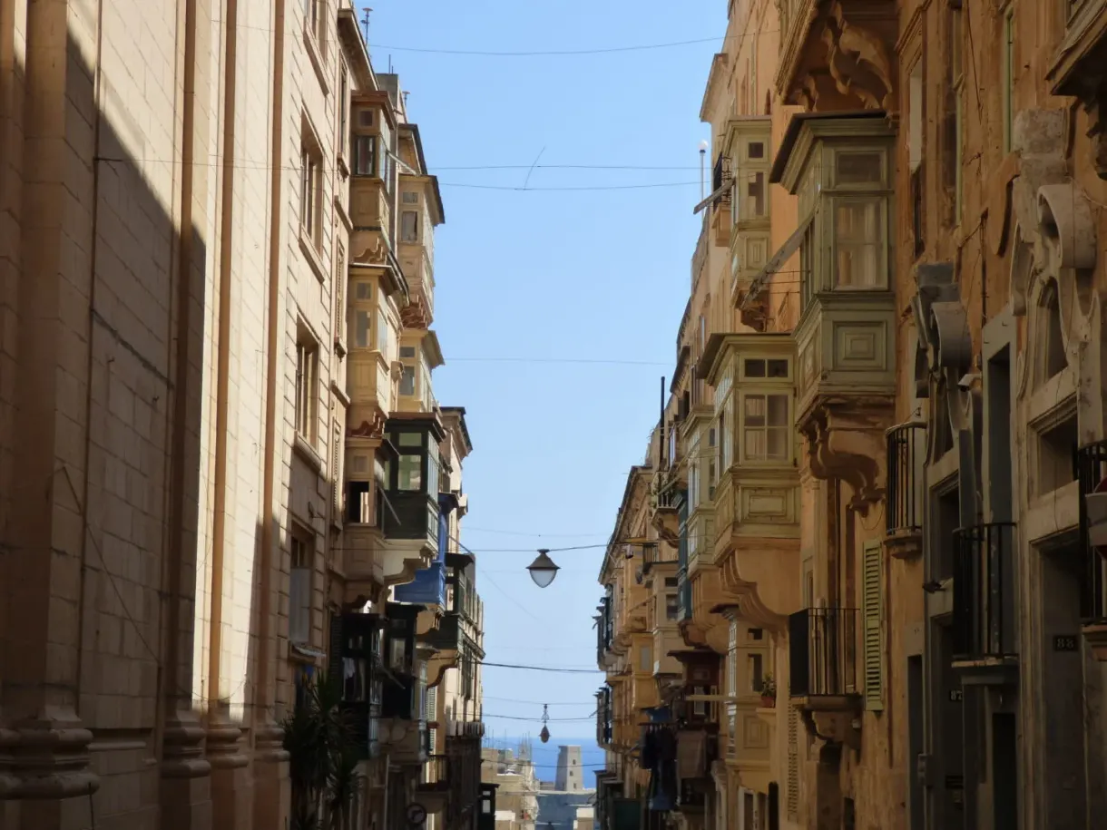 Narrow sloping street lined with wooden balconies