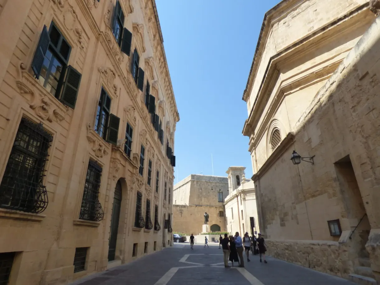 Street running down to the fort between two tall facades