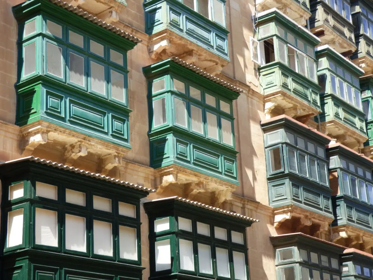 Green and turquoise wooden balconies packed side by side