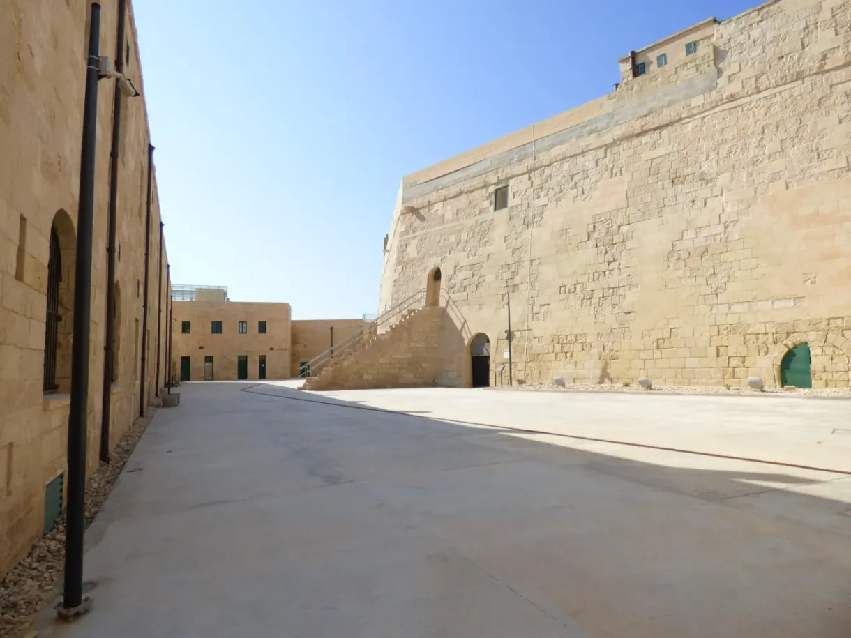 Empty courtyard between the high stone walls