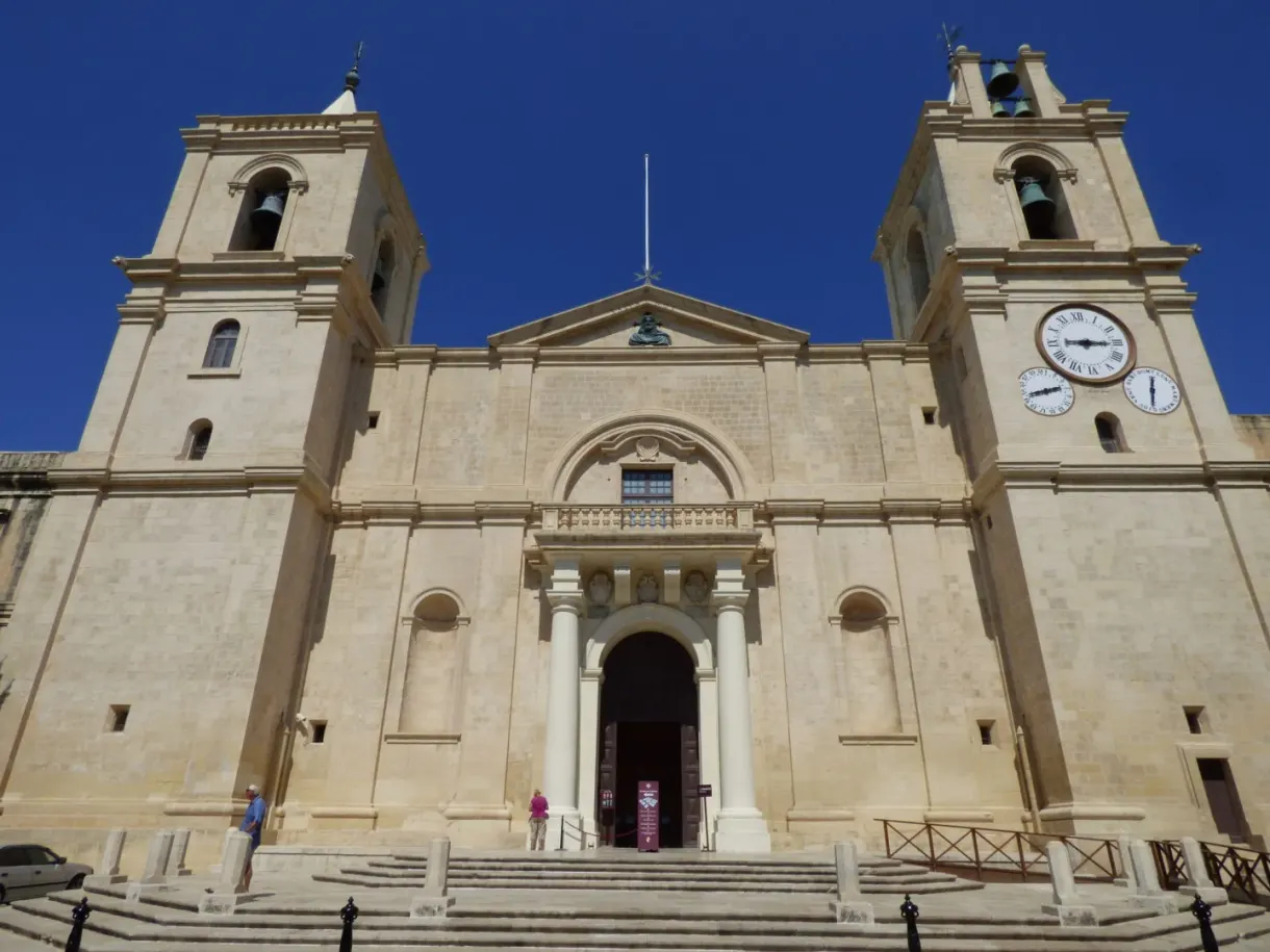 Plain facade with two bell towers and the cathedral clock