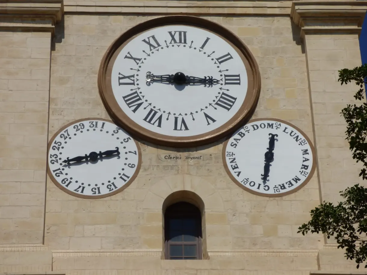 Clock with three faces on the stone bell tower