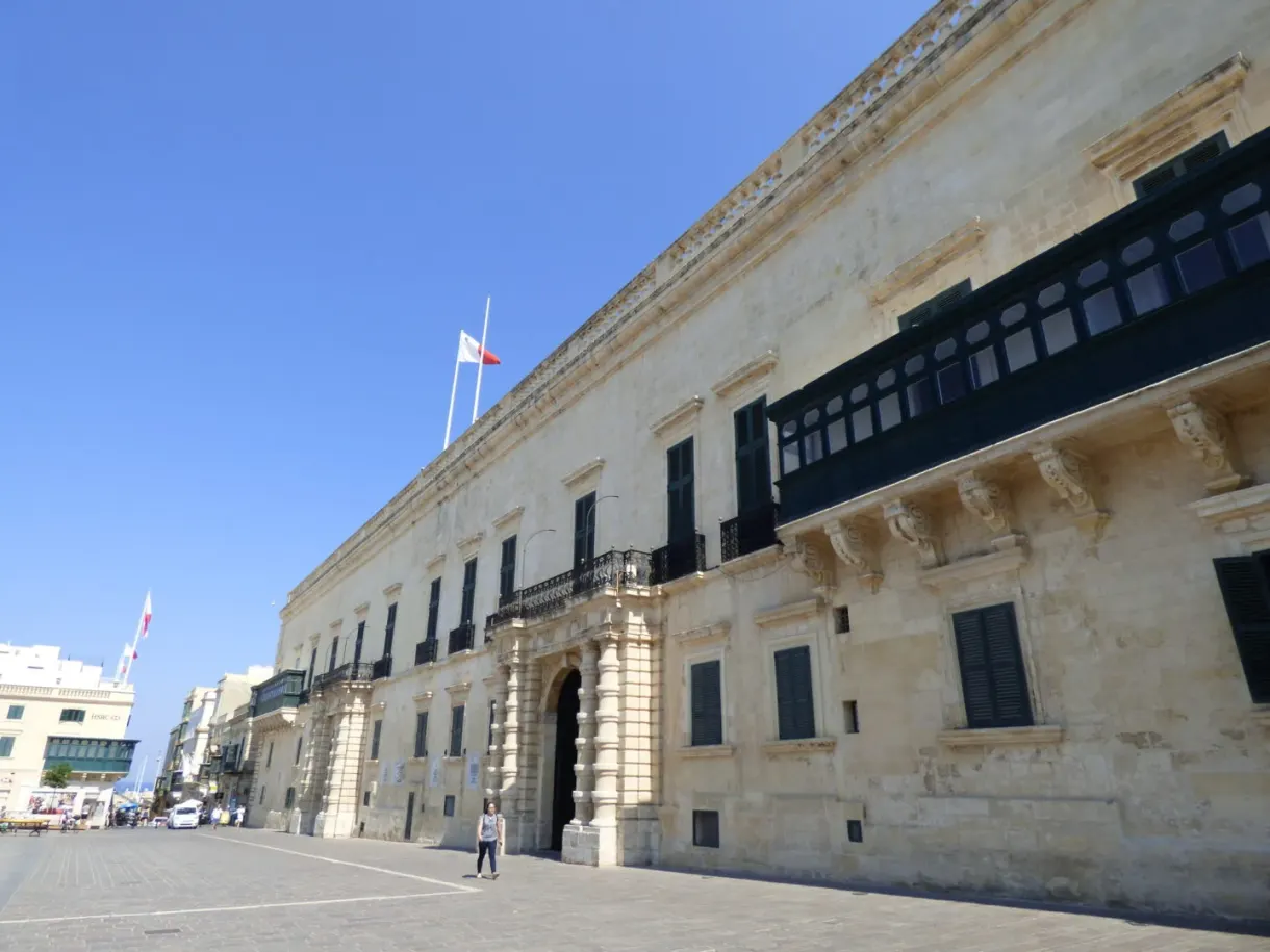 Long facade of the palace and its black balconies on the square