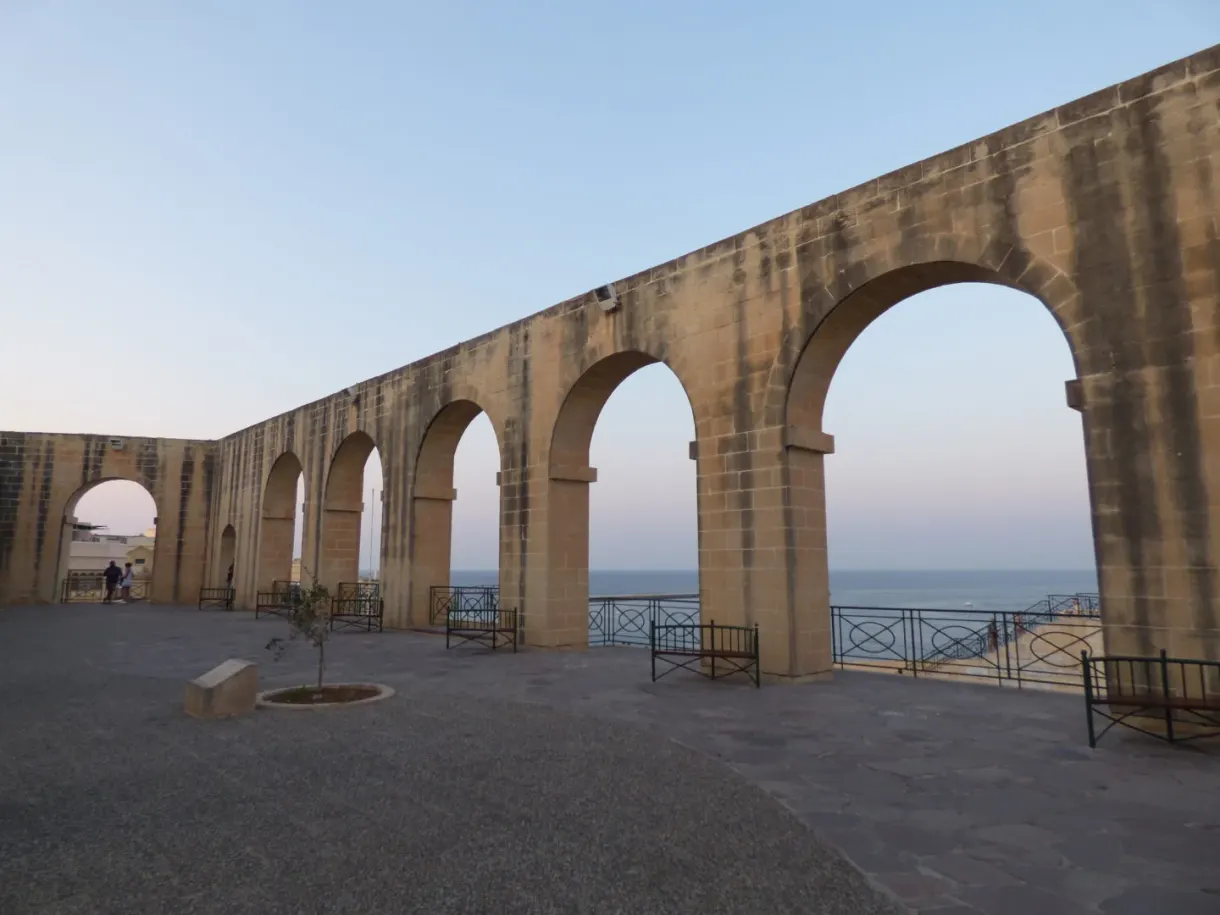Long stone arcade open onto the sea at the end of the day