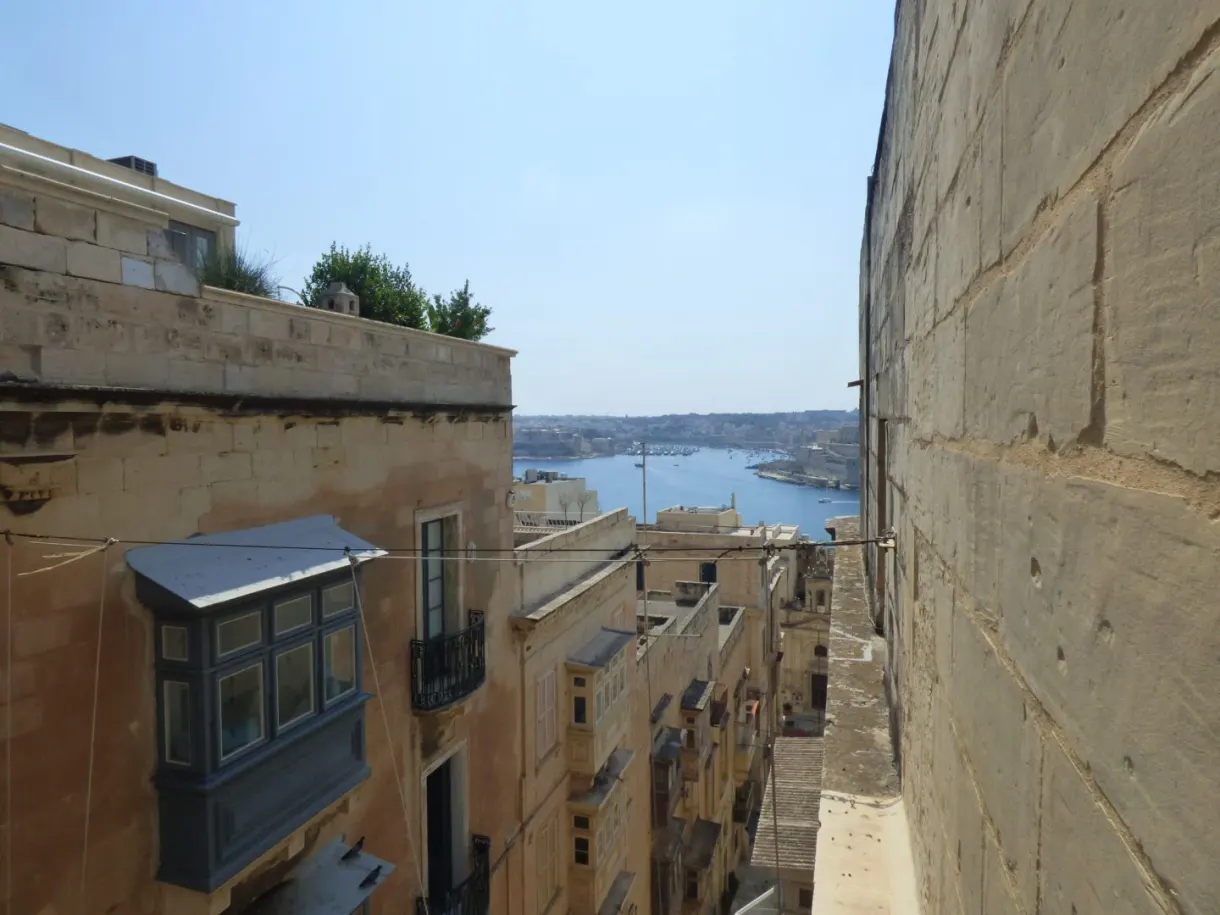 Lane sloping down to the water between two stone walls