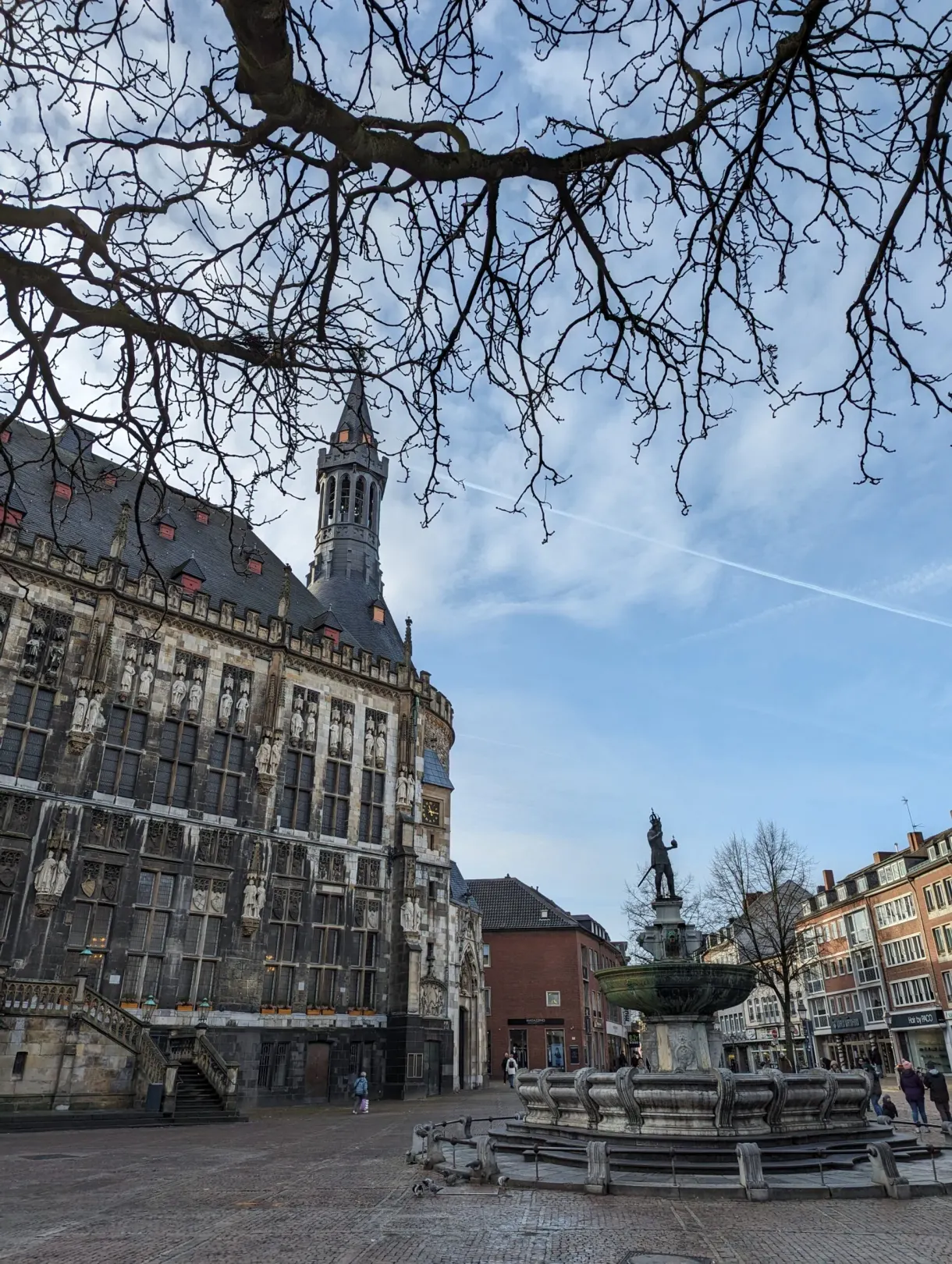 Aachen Cathedral seen from a distance with passersby out front