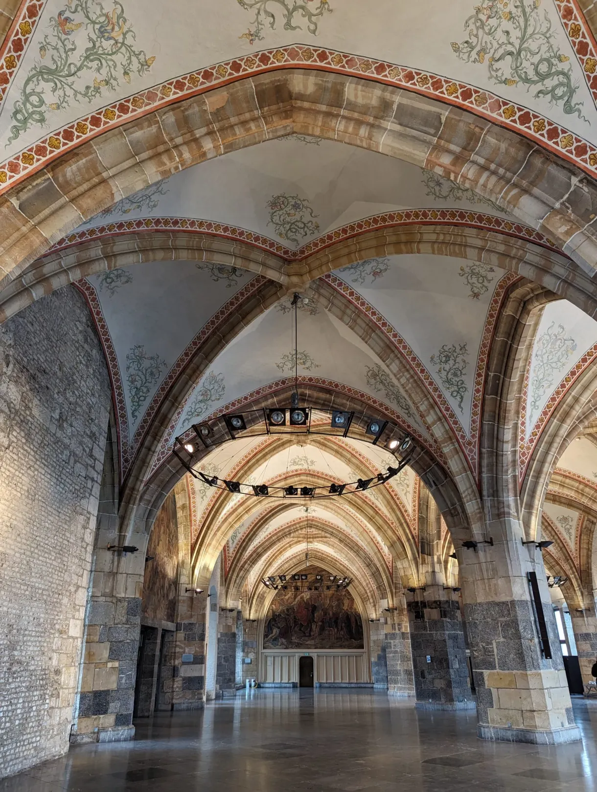 Low-ceilinged hall with stone vaults and flattened arches