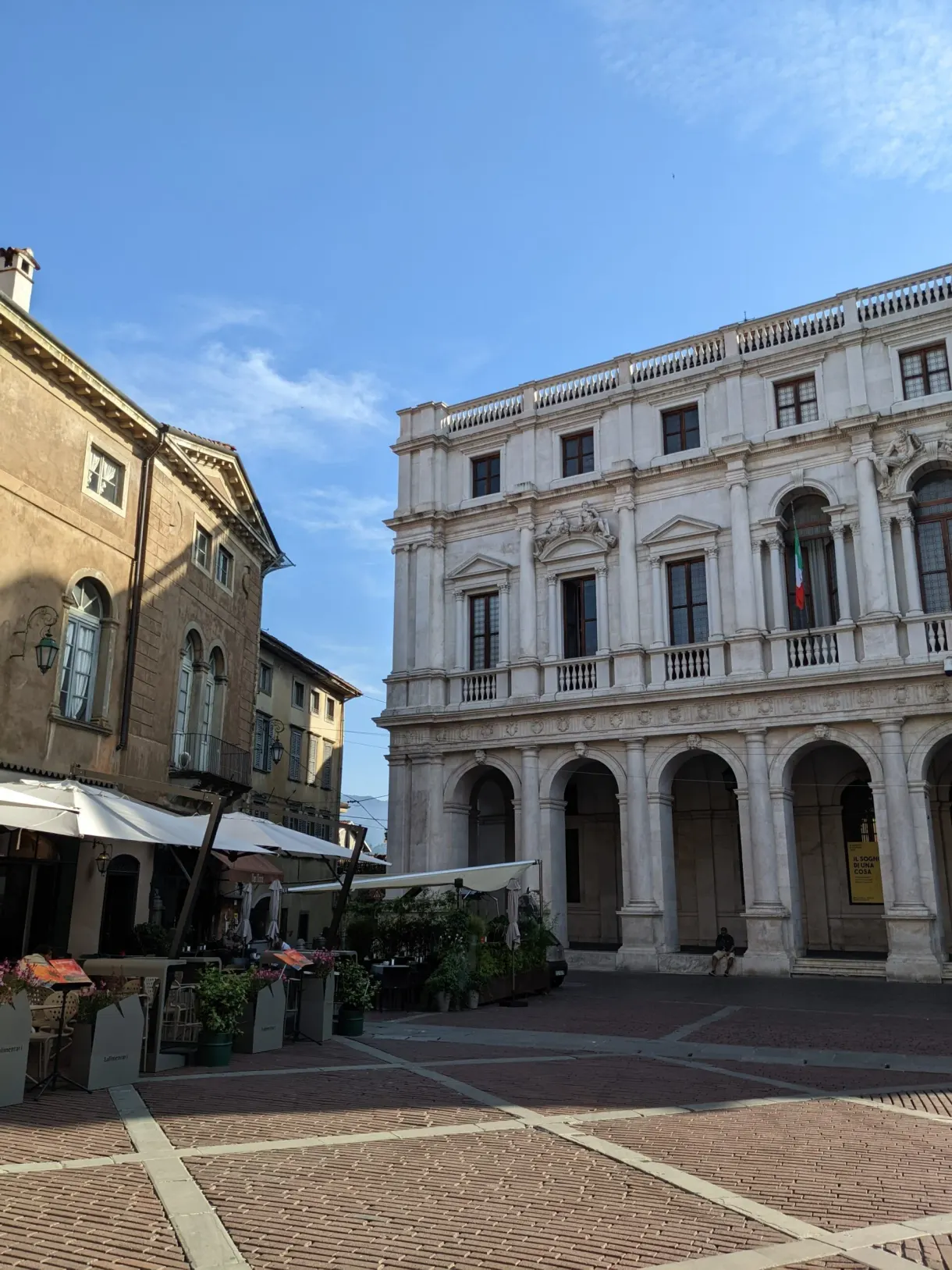 Renaissance palace with white arcades on a cobbled square