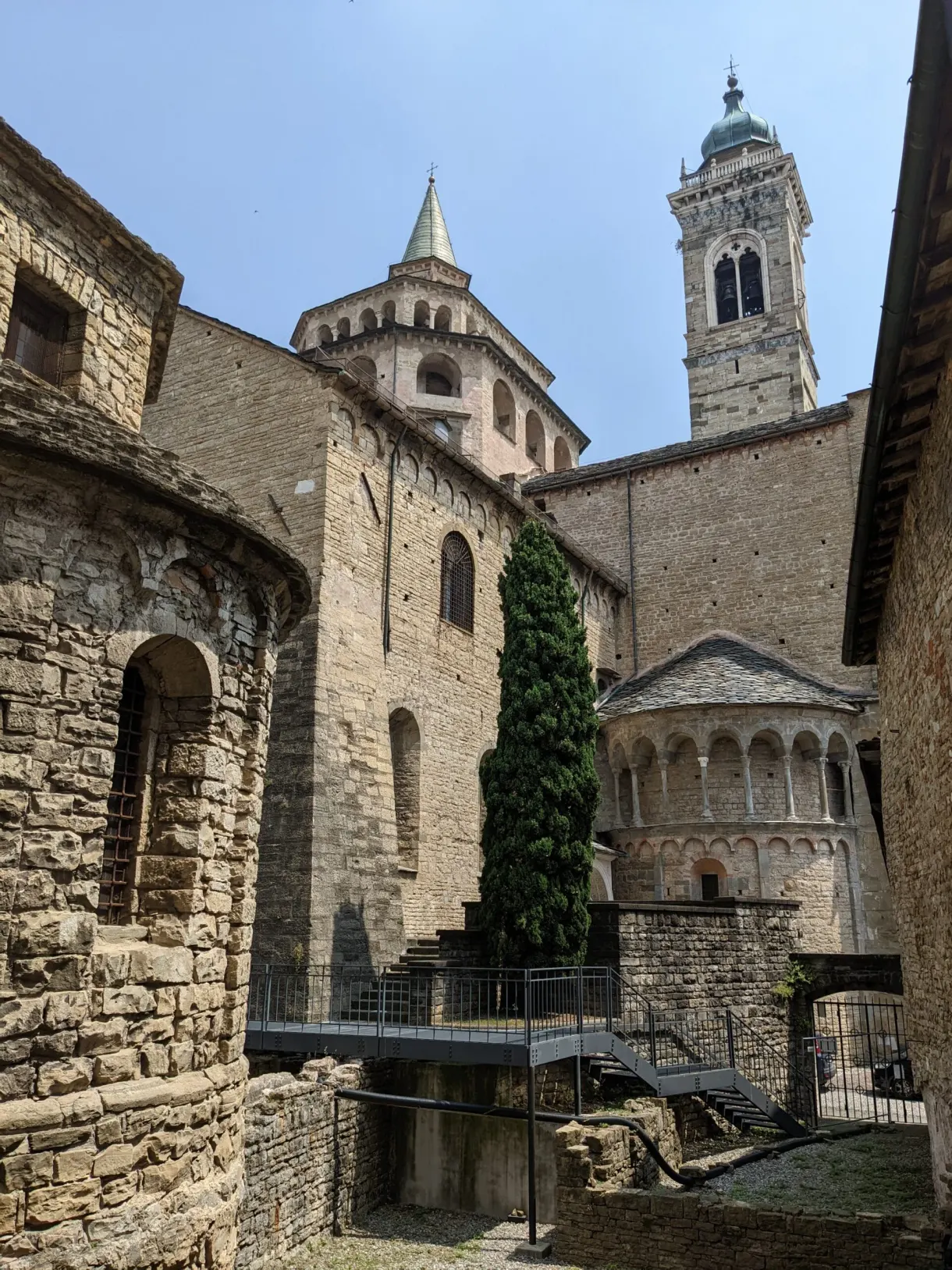 Romanesque stone apse and bell towers overlooking the old town