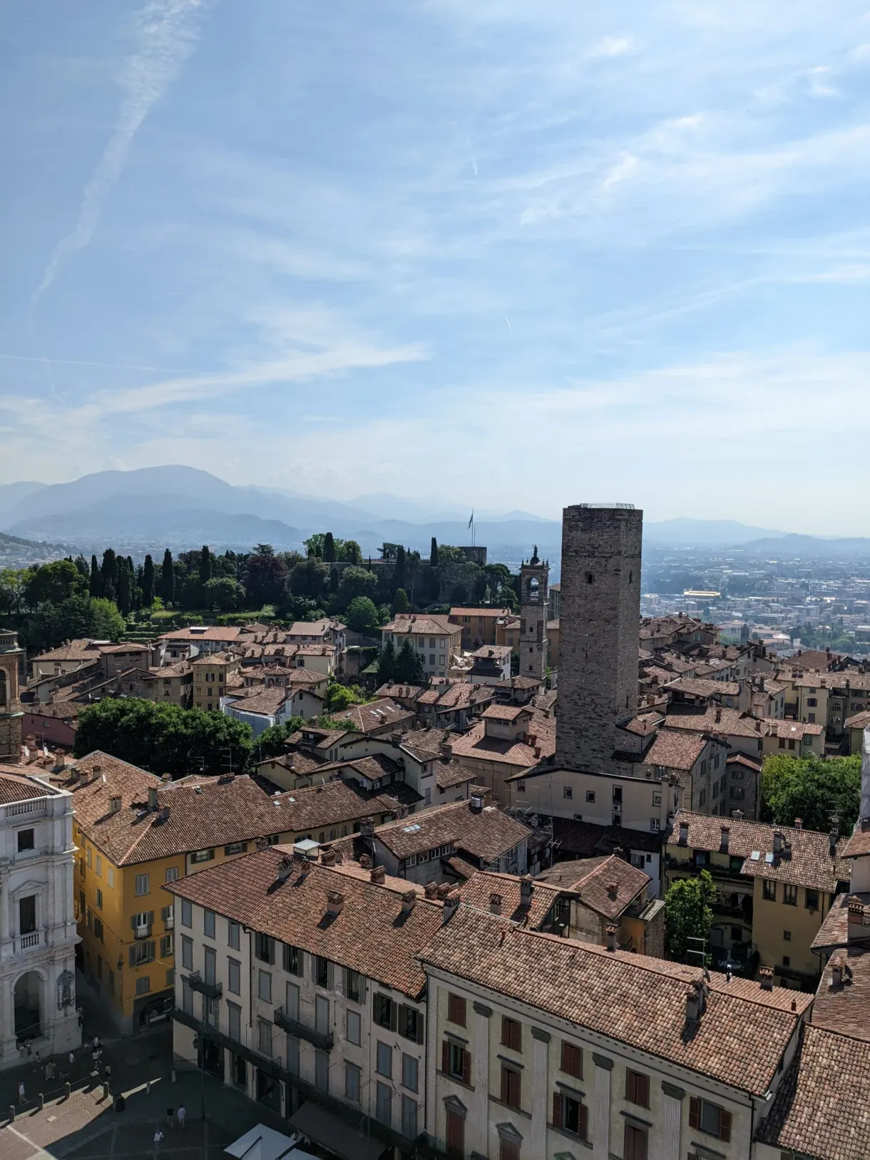 Tiled roofs and square tower above the plain