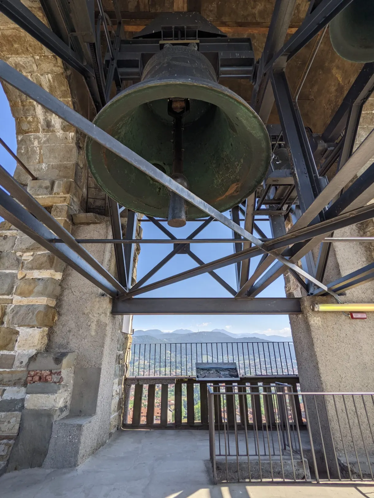 Large bronze bell hanging in the timber frame of the belfry