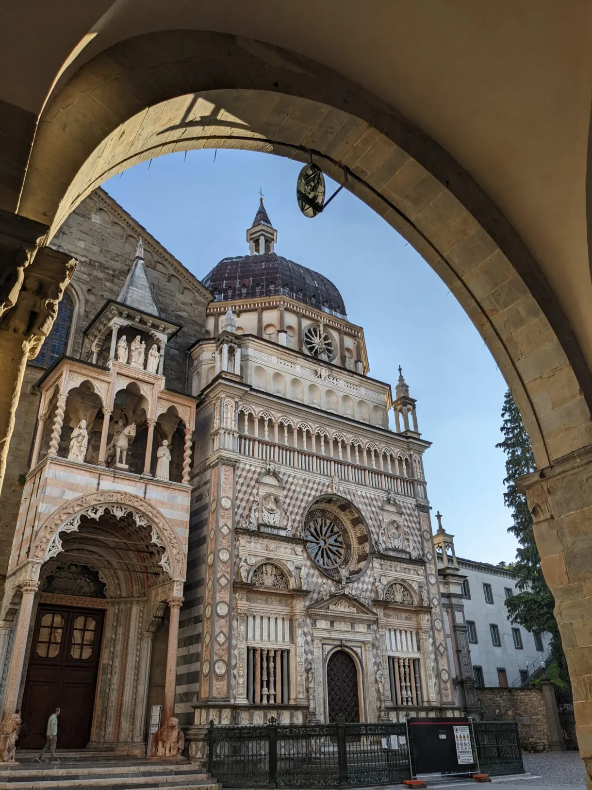 Polychrome marble facade framed by a large arch