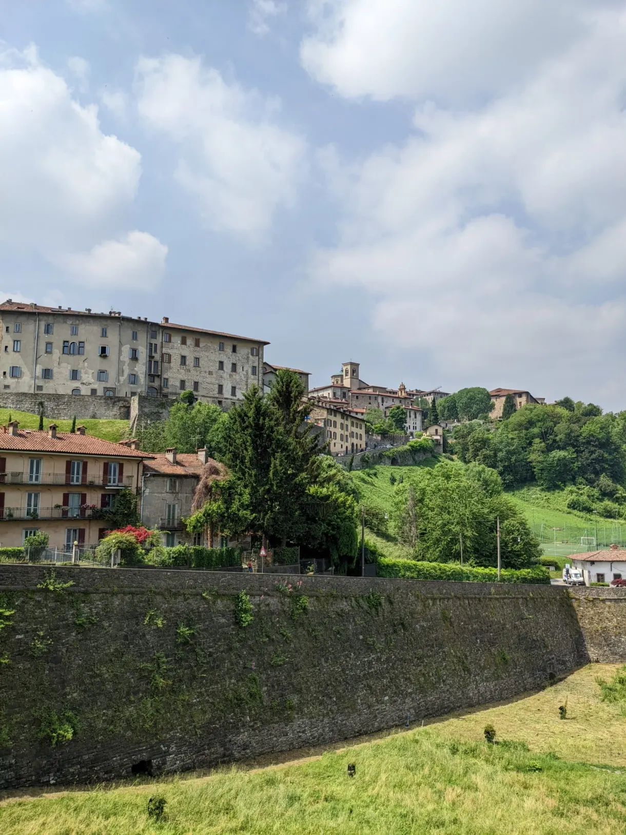 Curve of the wall beneath the perched buildings