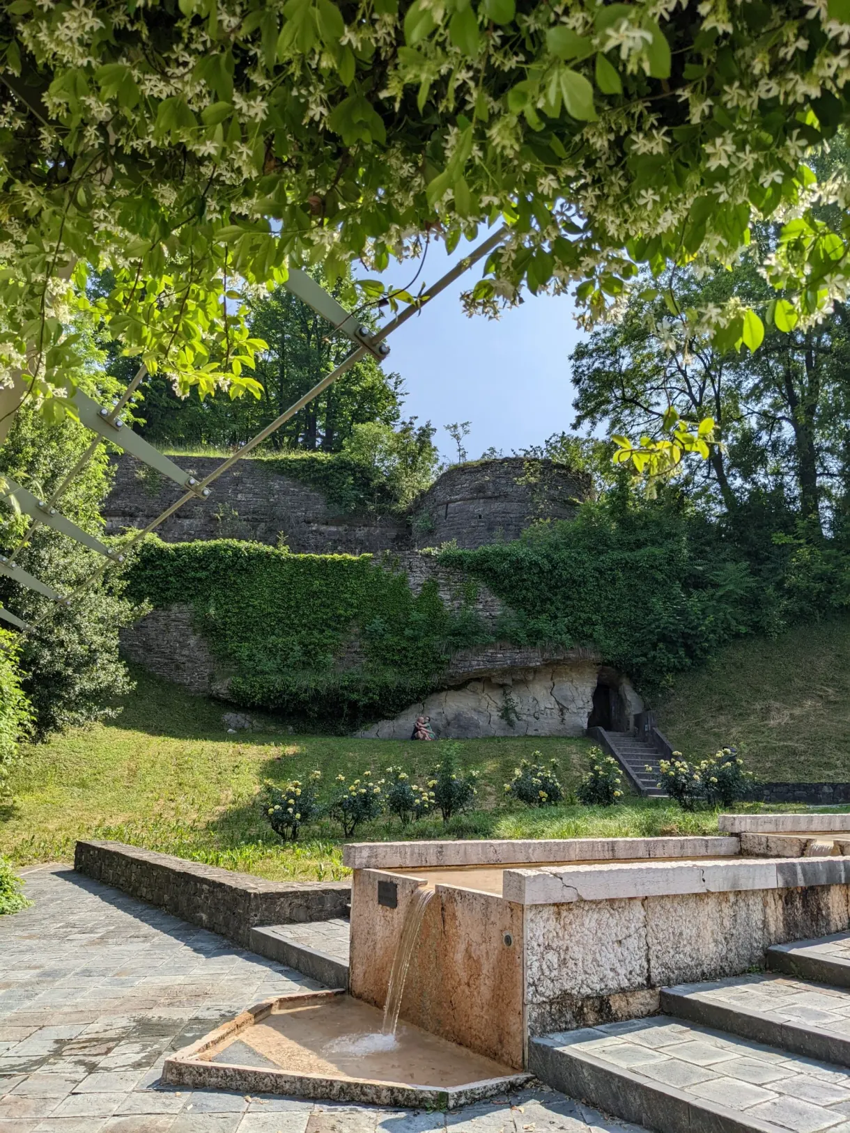 Stone trough at the foot of a planted bank
