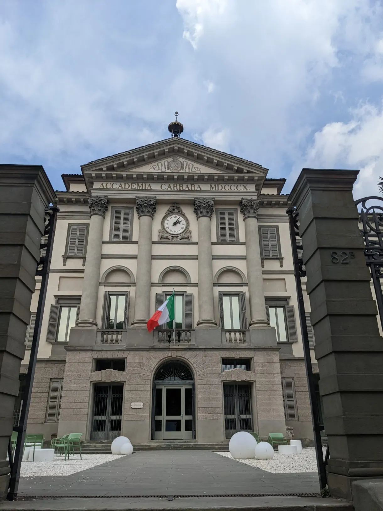 Palace with a pediment and clock, Italian flag on the balcony