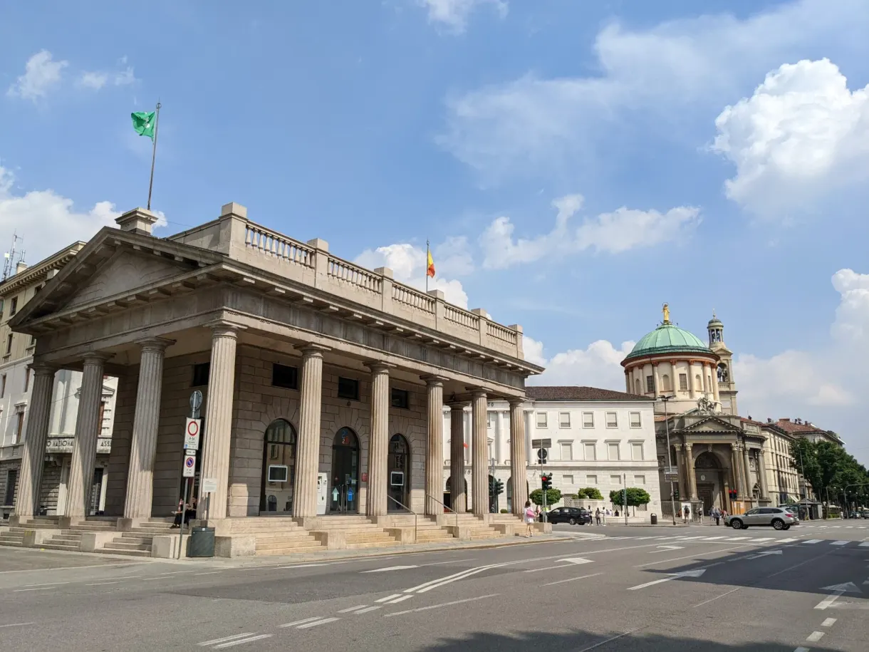 Neoclassical colonnade and green dome at the end of a deserted street