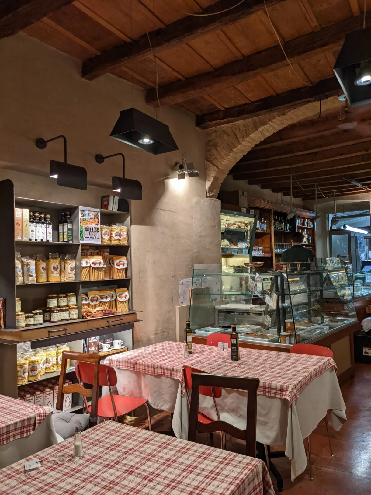 Restaurant room with checked tablecloths and exposed beams