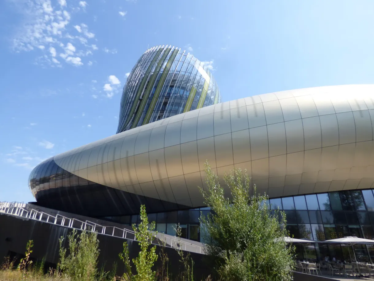 Coque d'aluminium brillante de la Cité du Vin sous un ciel bleu